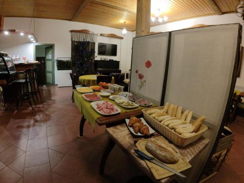 a table with bread and other food on it at Penzion SPORTINO in Svoboda nad Úpou