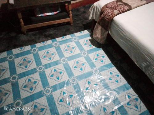 a blue and white tiled floor in a bedroom at Cosy budget Single room in Nairobi