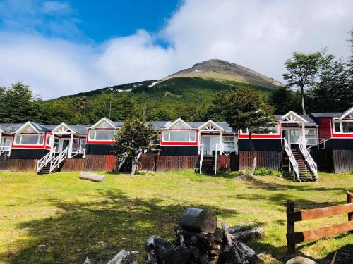 a row of houses with a mountain in the background at Cumbres Del Martial in Ushuaia