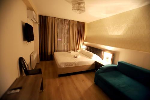 a hotel room with a bed and a couch at The K Tbilisi in Tbilisi City