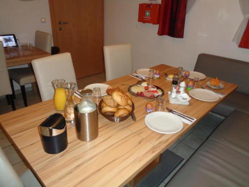 a wooden table with a plate of food on it at Eckenhof in Sankt Michael im Lungau