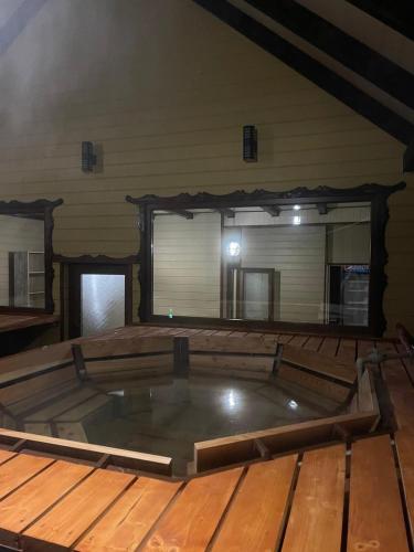 a pool in the center of a room with a wooden floor at Skarbivka in Vorokhta