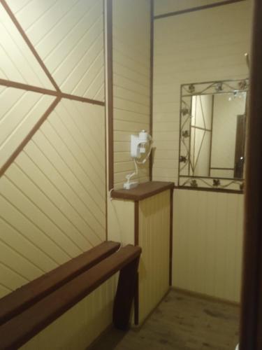 a bench in a room with a mirror and a mirror at Skarbivka in Vorokhta