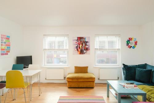 a living room with a couch and a table at Bath Breaks Apartments in Bath