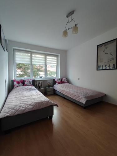 Apartament Brama Bałtyku tesisinde bir odada yatak veya yataklar