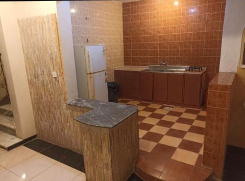 eine Küche mit einer Theke und einem Waschbecken in einem Zimmer in der Unterkunft شاليه للايجار الدرب ١ in Qarār