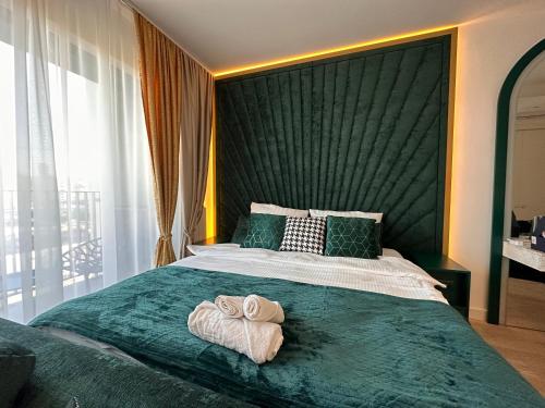 a bedroom with a large bed with towels on it at Belgrade Waterfront Luxury Apartment in Belgrade