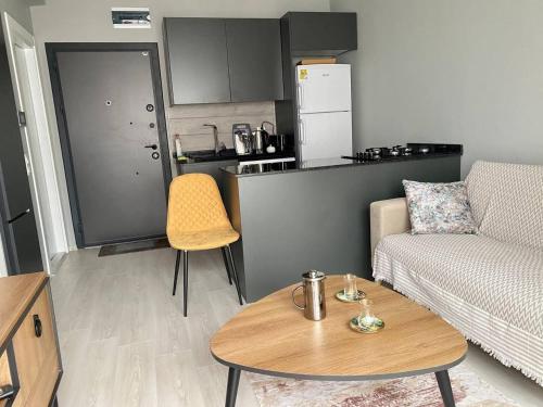 een woonkamer met een bank en een tafel bij Sahil One bedroom Apartment in Mezitli