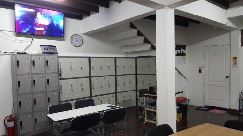 a room with lockers and a tv on a wall at Punsuk in Khon Kaen