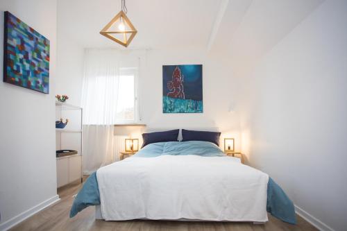 a bedroom with a bed with a blue and white bedspread at Alte Vikarie in Winterberg