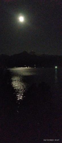 a full moon over a body of water at night at Suite doble Coñaripe in Coñaripe