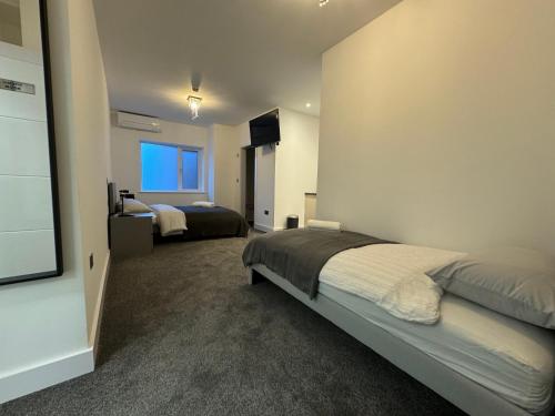 a bedroom with two beds and a large window at Seafarers Stays in Southampton