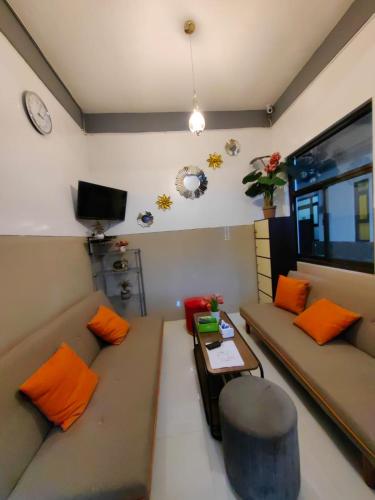 a living room with a couch and a table at Pondok Syariah Hadikusuma 