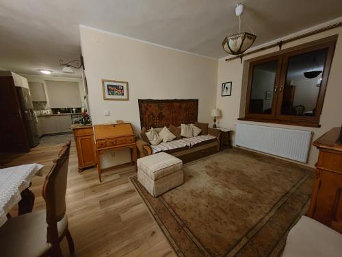 a living room with a couch and a table at Akacja Apartament in Rzeszów