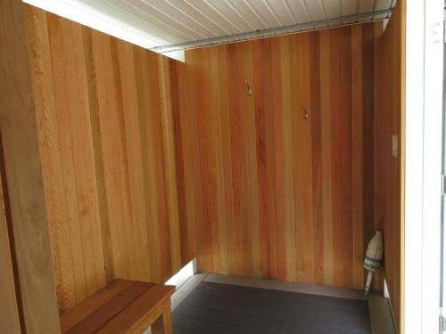 a room with wood paneled walls and a wooden bench at Close Walk To The Beach, The Perfect Home For A Single Family, in Harvey Cedars