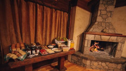 a table with food next to a fireplace at Τετραπολις Wellness Farm 