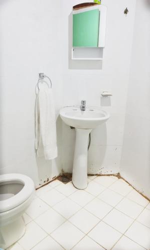a white bathroom with a sink and a toilet at Depto confortable para 4 Personas in Posadas