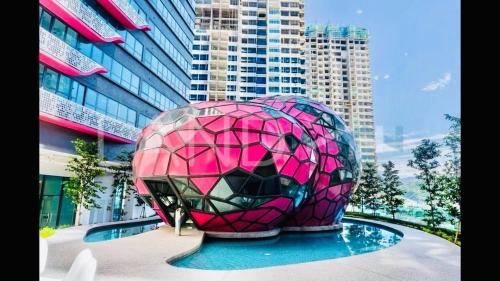 a large pink and black object in front of a building at Arte Plus Ampang KLCC City in Kuala Lumpur