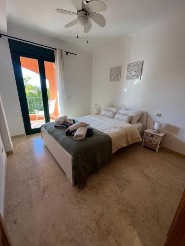 a bedroom with a bed and a ceiling fan at apartment nearby beach and old town Javea in Jávea