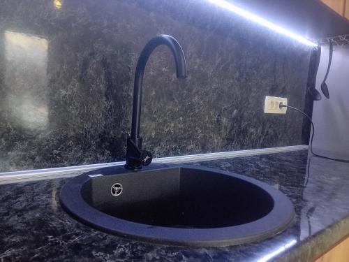a black sink with a faucet on a counter at Villa Green in Mostar