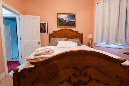 a bedroom with a large wooden bed with white sheets at Exquisite Victorian in Springfield