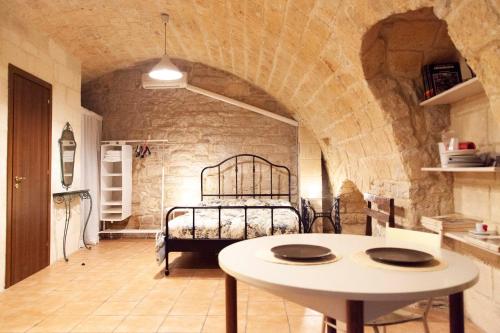 a room with a bed in a stone wall at Casa Vacanze Scolanova in Trani