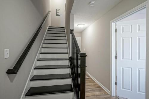 a staircase with white walls and a white door at Carlena Massage Center in Indianapolis