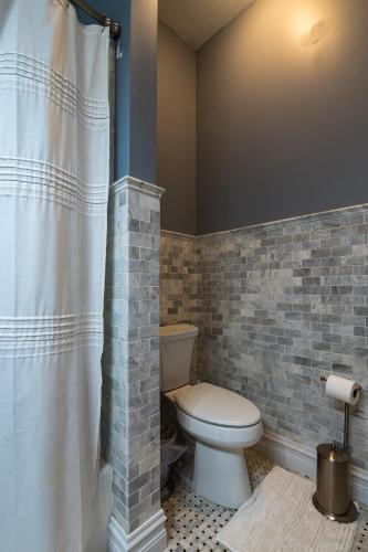 a bathroom with a toilet and a shower curtain at Exquisite Victorian in Springfield