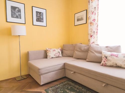 a living room with a couch and a window at Modern Apartment - Prague Centre in Prague