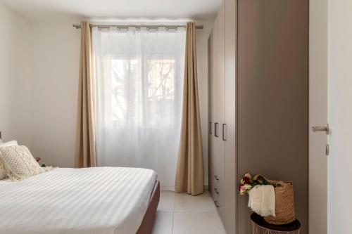 a bedroom with a bed and a window at Lugano Superior Suites - Free Parking in Lugano