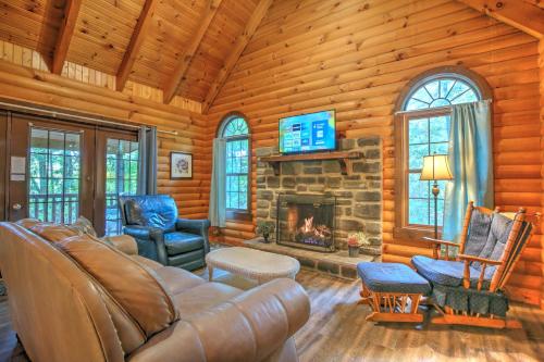 a living room with a couch and a fireplace at Grapevine Cabin by Amish Country Lodging in Millersburg