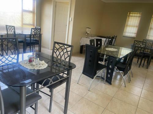 a dining room with black tables and chairs at Chamo bed and breakfast in East London