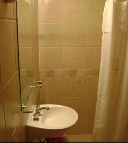 a bathroom with a sink and a shower at Hotel Rivamar in Mar del Plata
