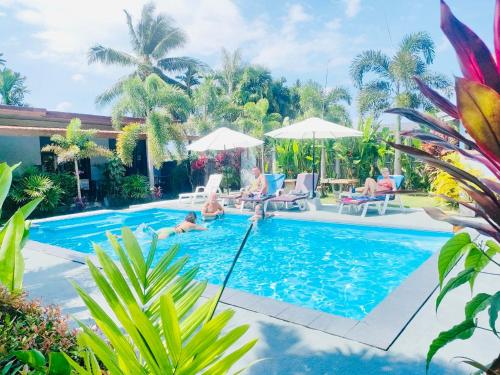 a group of people in the swimming pool at a resort at Andawa Lanta Resort in Ko Lanta