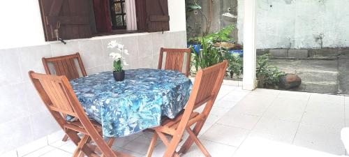a table with a blue table cloth on a patio at Mimi in Vieux-Habitants