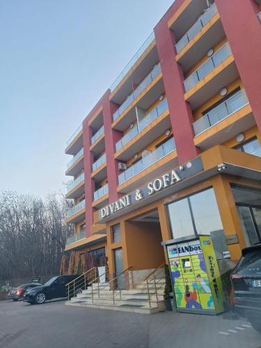 a building with a sign that reads drink and sofa at Apartament Complex in Bucharest