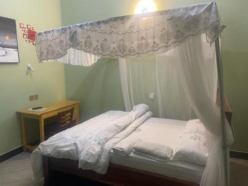 a bed with a canopy in a room at The first royal tour lodge in Dodoma