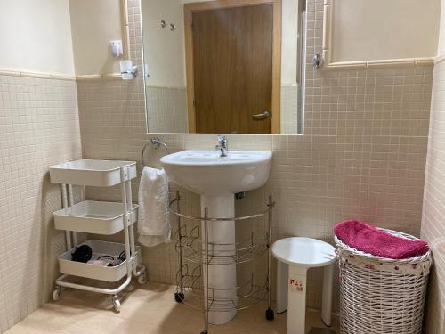 a bathroom with a sink and a mirror at El Mirador de Ines in El Puerto de Santa María