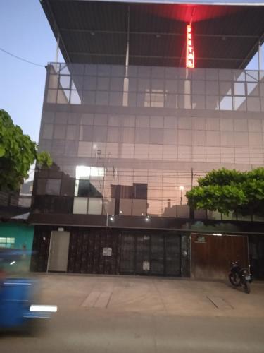 a building with a motorcycle parked in front of it at Los Kristales in Tingo María