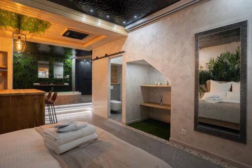 a bedroom with a bed and a bathroom at Le Nature - Sauna - Balnéo - Sparoom Sarreguemines in Sarreguemines