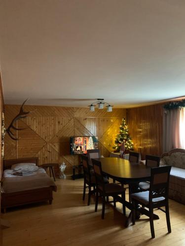 a living room with a table and a christmas tree at Під Боржавою in Volovets