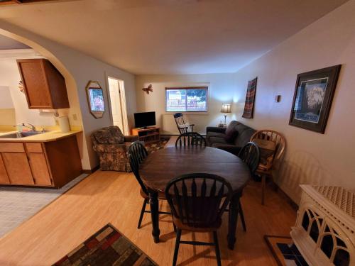 a kitchen and living room with a table and chairs at Alexander's Lodge in Ashford