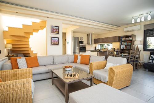 a living room with a couch and a table at Villa Aggemari in Apidias Lakos
