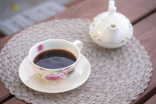 a cup of coffee and a tea pot on a table at Villa Aggemari in Apidias Lakos