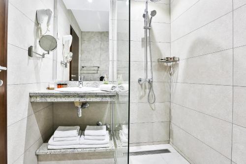a bathroom with a shower and a sink at Hotel La mer in Budva