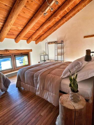 a bedroom with a large bed and a wooden ceiling at Agriturismo del Cimone in Fanano