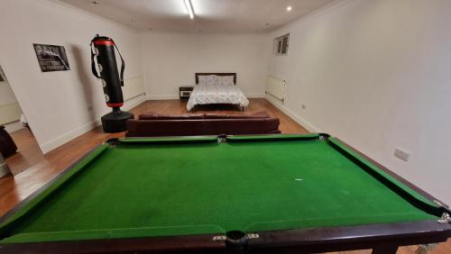 a living room with a pool table and a couch at Large Annexe Sleep upto 8 in Windsor