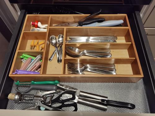 a wooden drawer with utensils in it at Akacja Apartament in Rzeszów