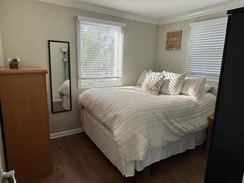 a bedroom with a bed with a mirror and a window at Fantastic Ocean Views From This First Floor Ocean Front Duplex In Harvey Cedars in Harvey Cedars