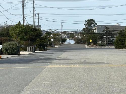 an empty street with a river in the distance at Fantastic Ocean Views From This First Floor Ocean Front Duplex In Harvey Cedars in Harvey Cedars